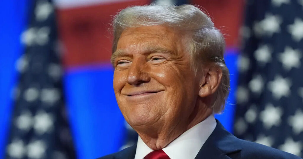 Donald Trump smiling for a photograph