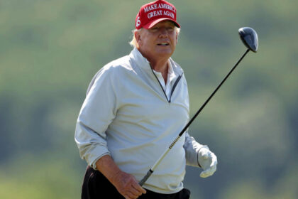 Donald Trump follows his tee shot during the pro-am prior to the LIV Golf Invitational - DC at Trump National Golf Club.