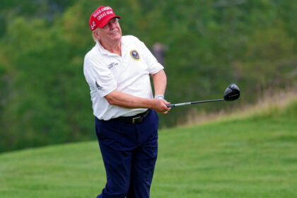 Donald Trump playing golf.