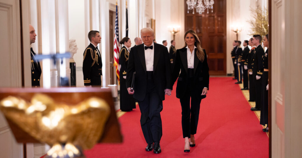 President Donald J. Trump and First Lady Melania Trump walk down the cross hall of the White House during the governor’s ball.