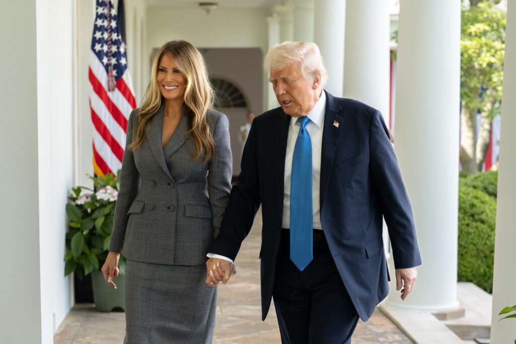 Donald and Melania Trump walking hand in hand in White House's Rose Garden
