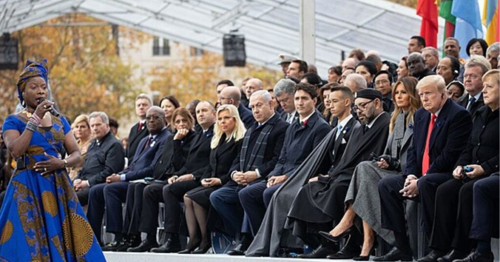 Donald Trump and Melania Trump listen to a singer at the Centennial of the 1918 Armistice Day ceremony Sunday, Nov. 11, 2018, at the Arc de Triomphe in Paris. Justin Trudeau is also seated in first row. 