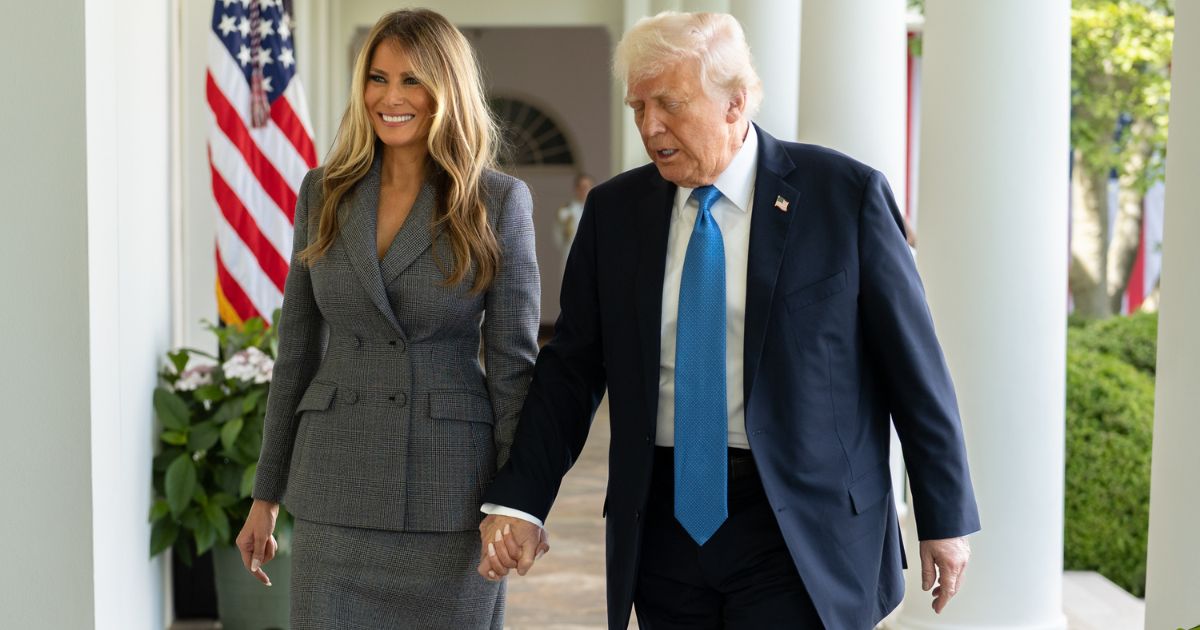 Donald and Melania Trump walking hand in hand in White House's Rose Garden (Image Source: X/@FLOTUS)