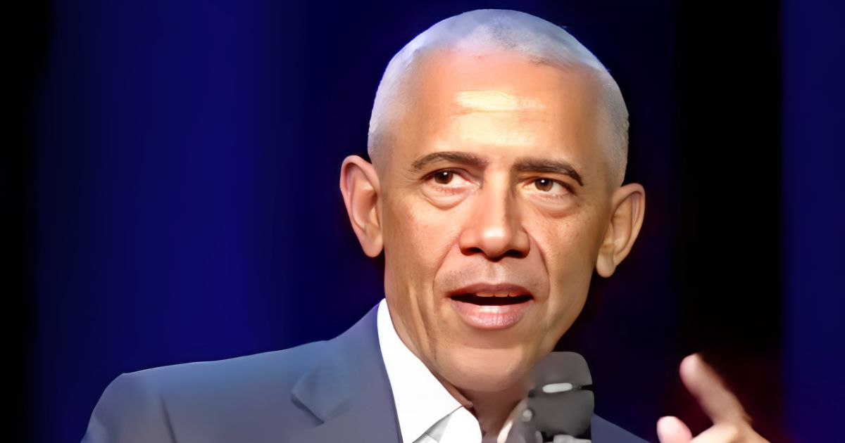 Barack Obama speaking into a microphone on stage at Hamilton College, calling out political double standards