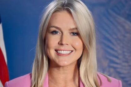 Karoline Leavitt smiling in a pink suit while promoting Trump’s “One Big Beautiful Bill” on Instagram.