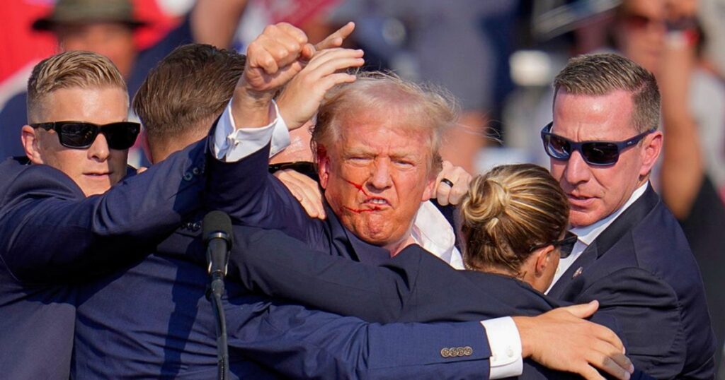 Donald Trump waving at supporters post-assassination attempt, July 2024