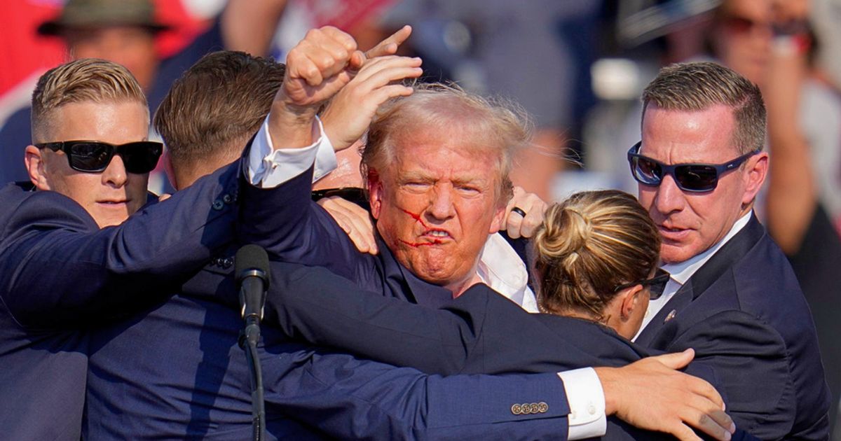 Donald Trump waving at supporters post-assassination attempt, July 2024