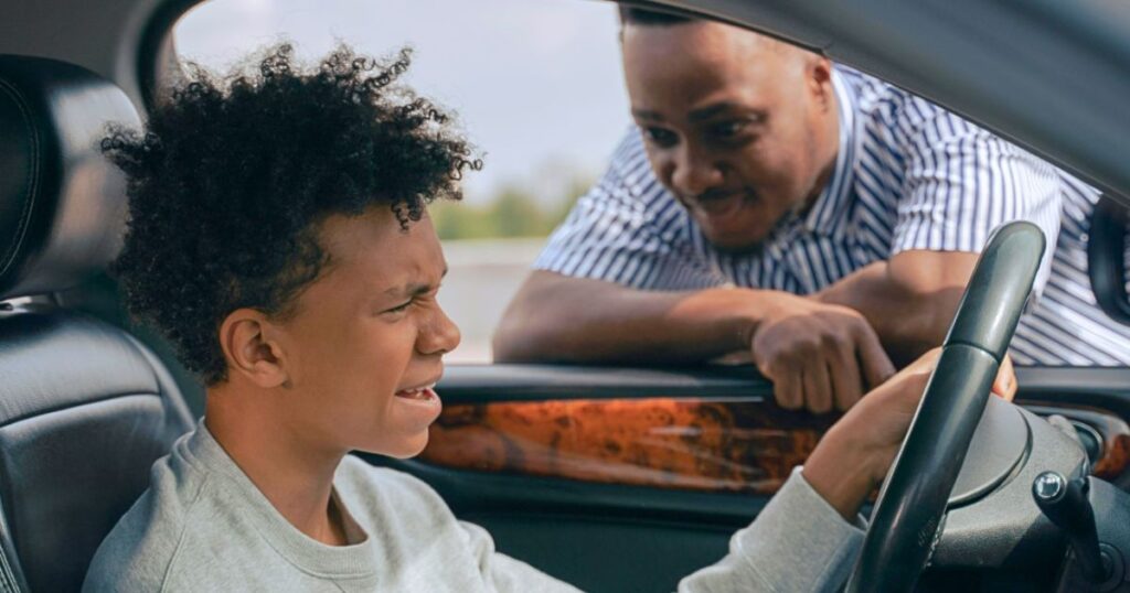 A teenage boy practices driving with her father as Florida’s new 50-hour training law takes effect