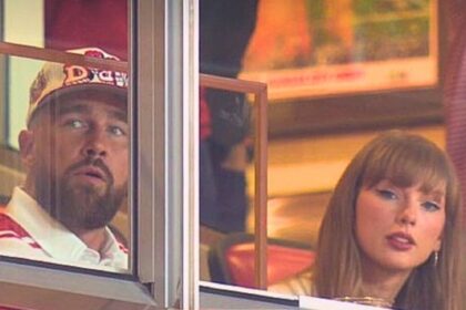 Taylor Swift and Travis Kelce sitting together at a college football game after announcing their engagement.