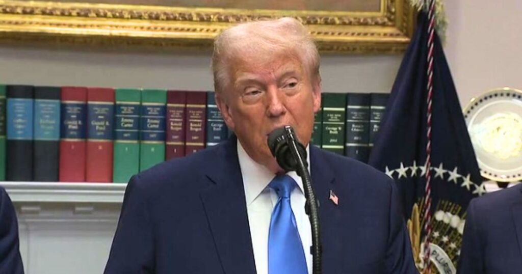 Donald Trump at a press podium making remarks about Democrats and Tylenol.