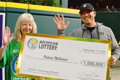 Valerie Williams holds her $1 million check after the Michigan Lottery Electric Giveaway