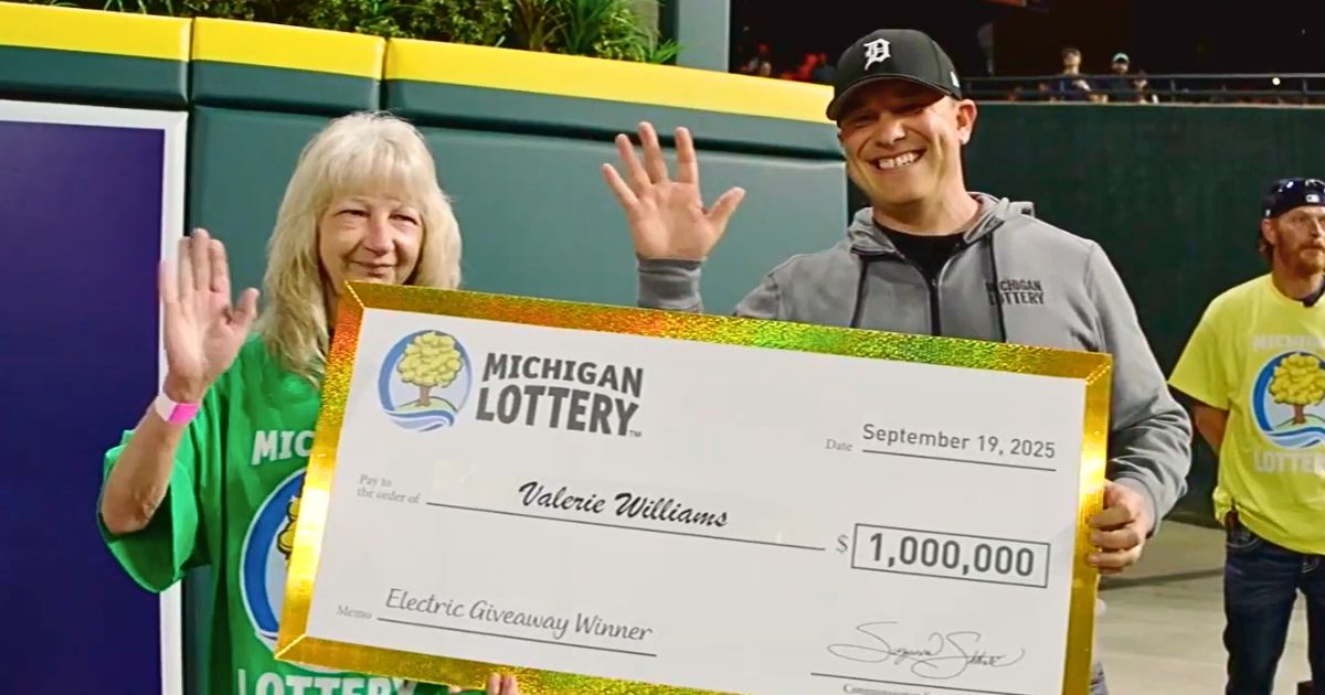 Valerie Williams holds her $1 million check after the Michigan Lottery Electric Giveaway