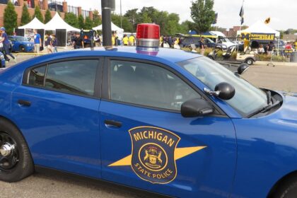 Freshman police officer helps Michigan woman deliver baby at the side of road with help from dispatcher brother