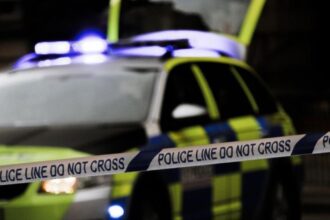 Man booked for pointing a gun towards a group of children singing Christmas carols at his door