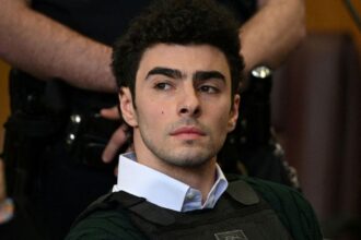 Luigi Mangione in court, pumps fist then cop speaks of ammunition hidden in wet underwear