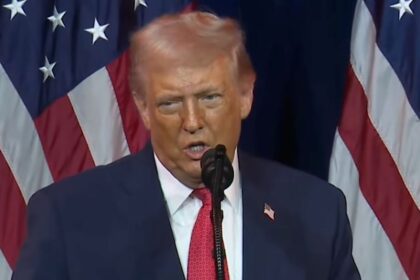 Donald Trump sported pink hair and a shiny orange spray tan job during his recent address at Kennedy Center.