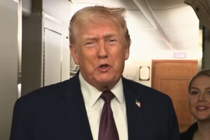 Donald Trump addressing reporters on Air Force One during a turbulent flight in January 2026