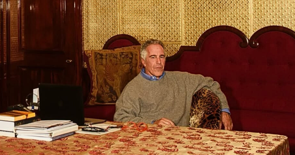 Jeffrey Epstein with files on desk