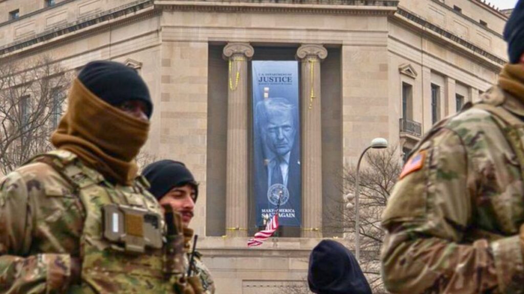 A banner featuring President Donald Trump and the slogan “Make America Safe Again” hangs over the Department of Justice headquarters.