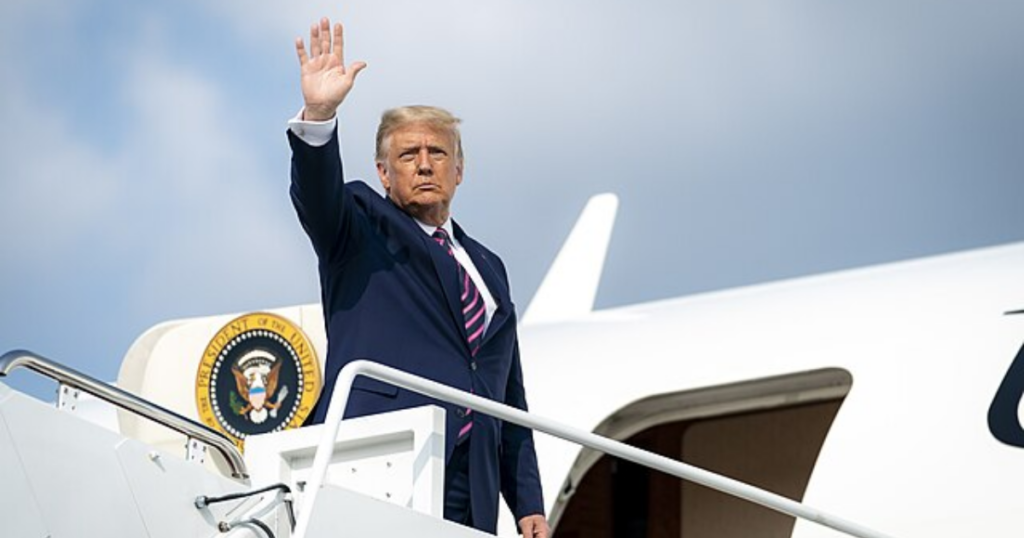 Donald Trump holds Melania Trump as he steps down AF1