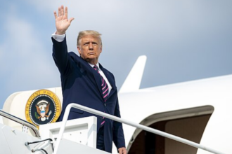 Donald Trump holds Melania Trump as he steps down AF1