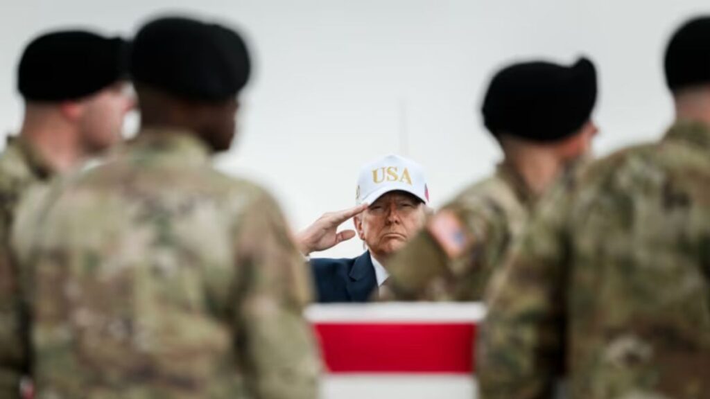 Donald Trump wears a white baseball fundraising cap at Dover during the dignified transfer of six U.S. fallen soldiers