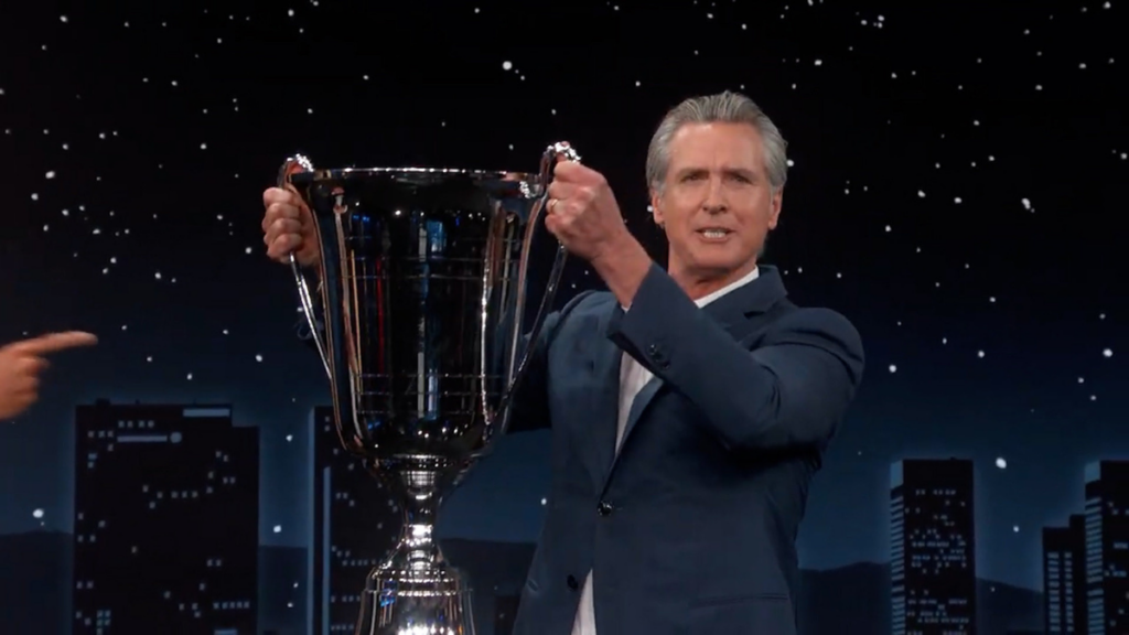 Gavin Newsom posing with his award