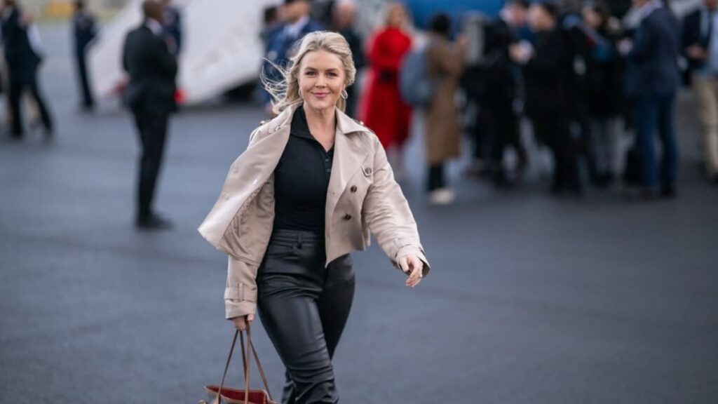 Karoline Leavitt wearing a luxury outfits along with a Louis Vuitton bag at a public event.