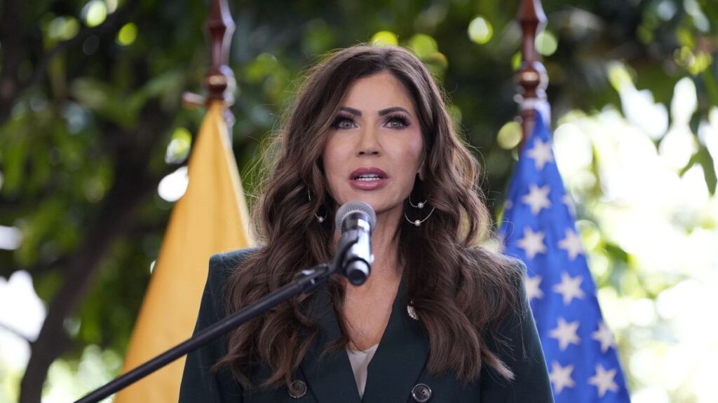 Kristi Noem giving a speech as she gets fired from her homeland post