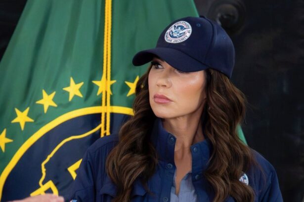 Kristi Noem speaking with a DHS law enforcement member amid ongoing controversy over her DHS exit.