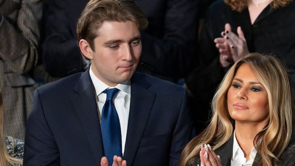 Barron Trump and Melania Trump applauding