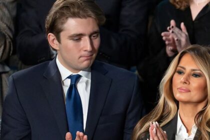 Barron Trump and Melania Trump applauding