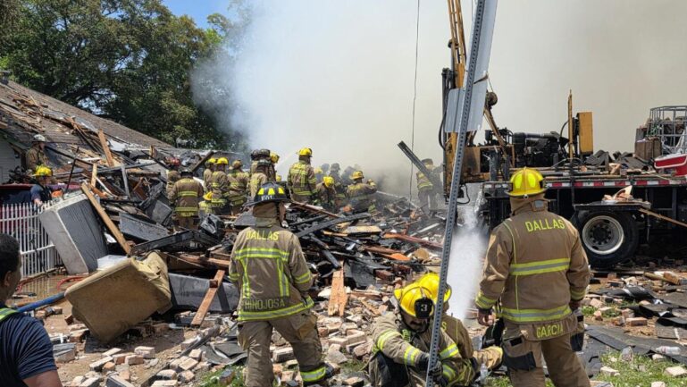 Dallas Fire-Rescue crews sift through debris after the Dallas apartment explosion escalated into a five-alarm fire.(Image Credits-@StevenDialFox4)