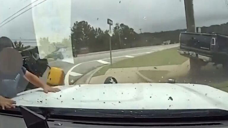 Child ejected from a vehicle and landed on a police vehicle