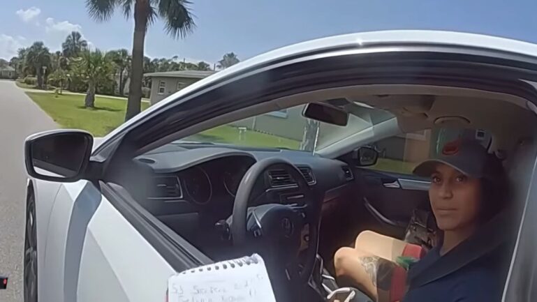 Woman arrested by police officer at minor traffic stop.